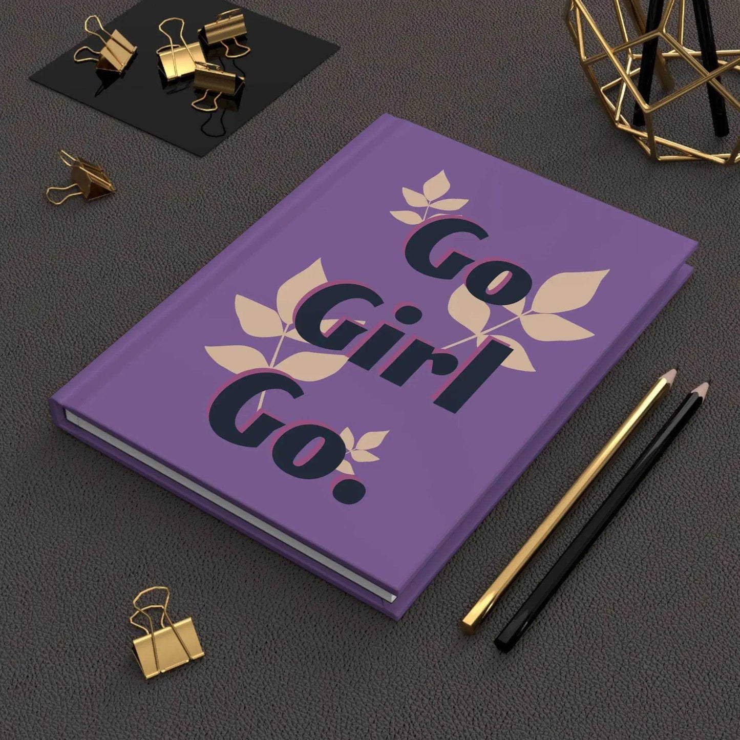 Motivational Empowering Journal with 'Go Girl Go.' cover design, styled with gold office supplies for a modern and inspiring workspace.