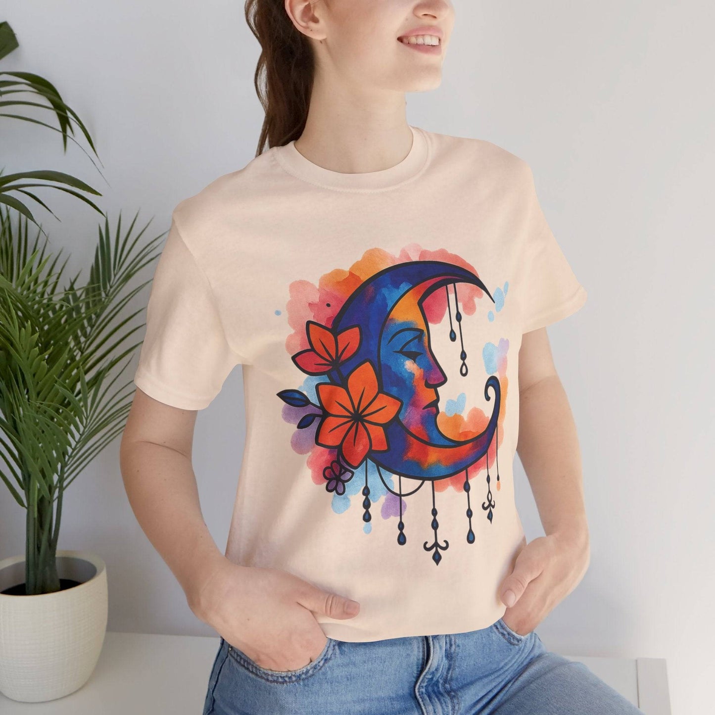 Peach Floral Moonface Goddess Tee with watercolor moon and flower design, a lightweight boho shirt for spiritual and hippie-inspired wardrobes.