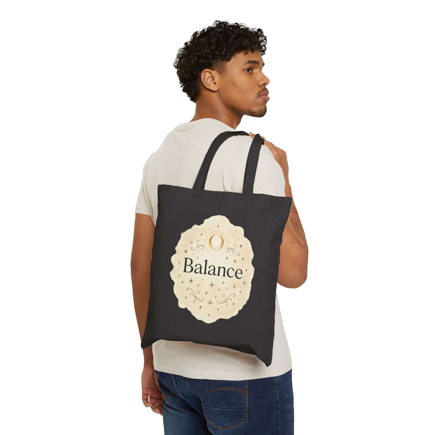 Man carrying a black tote bag with 'Balance' design on a white background