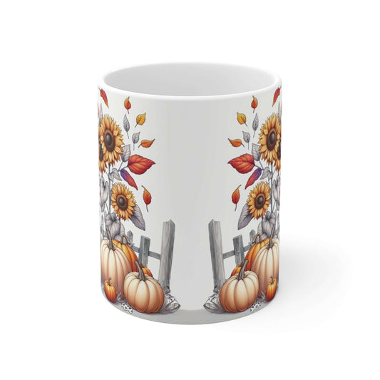 Mug with autumn-themed design featuring pumpkins, sunflowers, and leaves on a white background