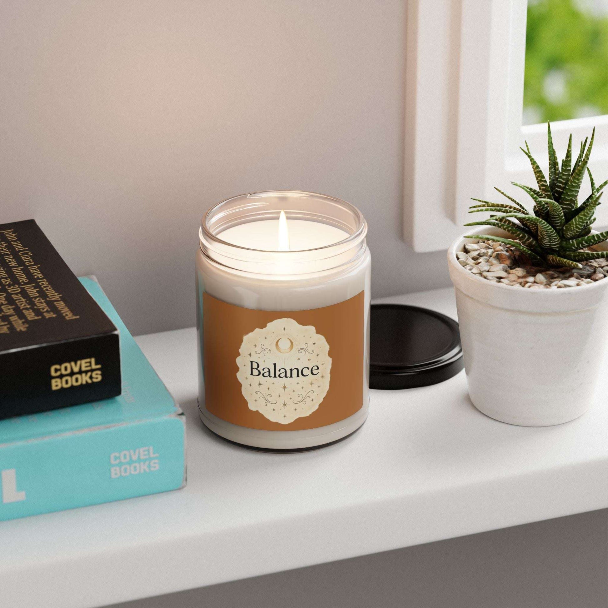 Candle labeled 'Balance' on a shelf with books and a plant