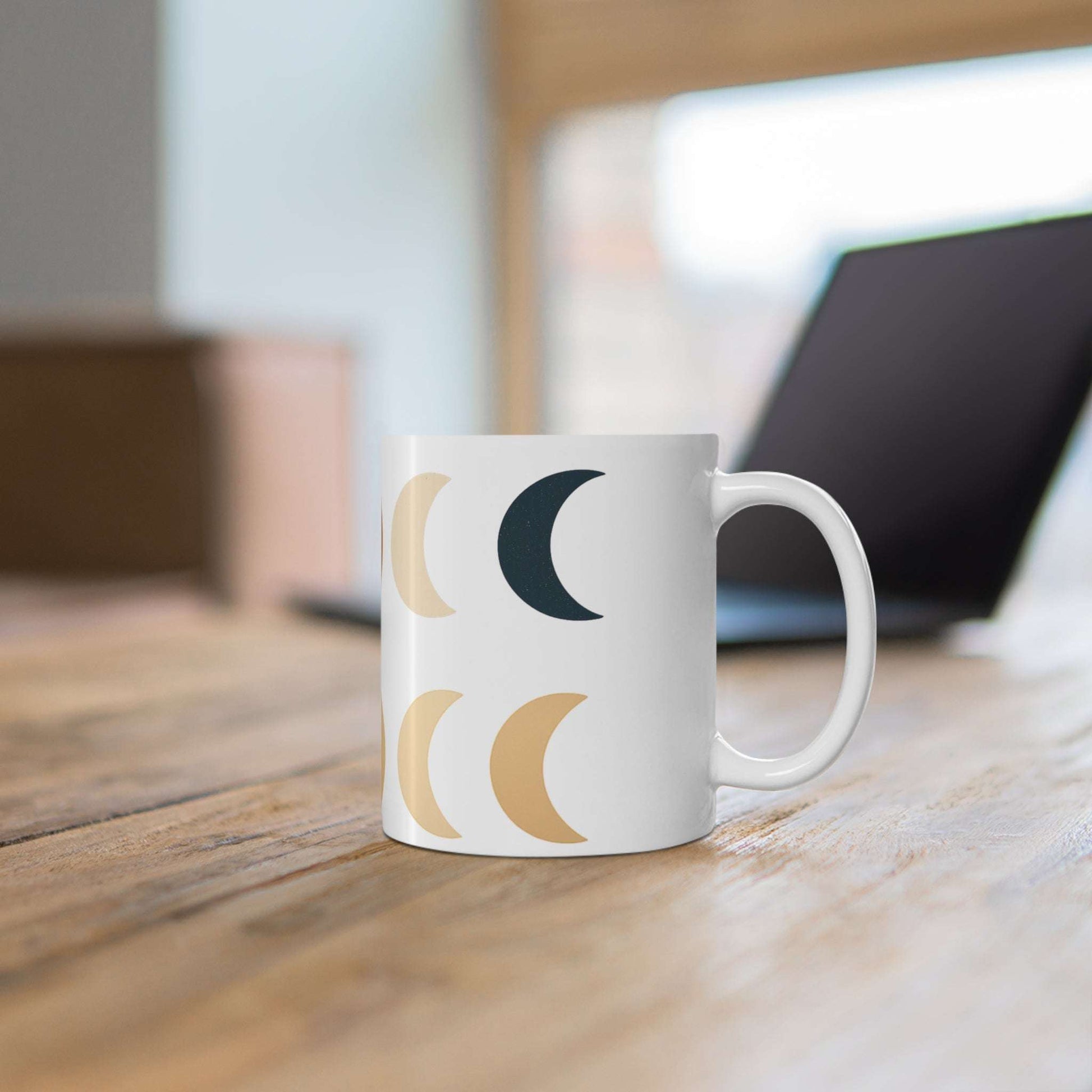 Boho Moon Phase Mug with calming lunar design in neutral tones, placed on a wooden desk for a cozy, aesthetic home and lifestyle vibe.