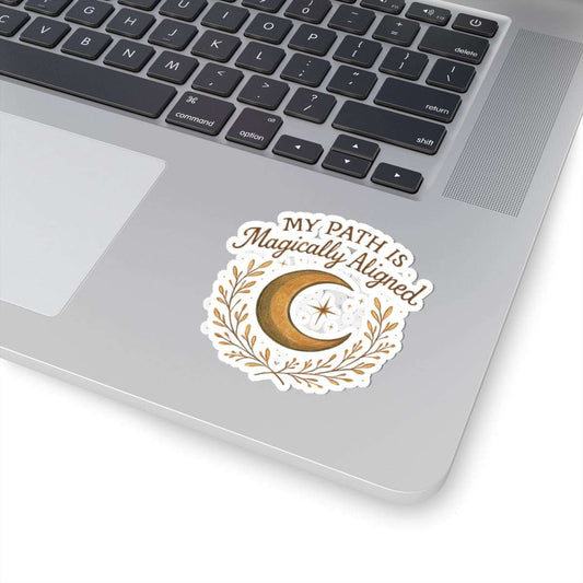 Crescent Moon 'My Path Is Magically Aligned' boho spiritual sticker on silver laptop near trackpad, ideal for intentional journaling or tech decor.
