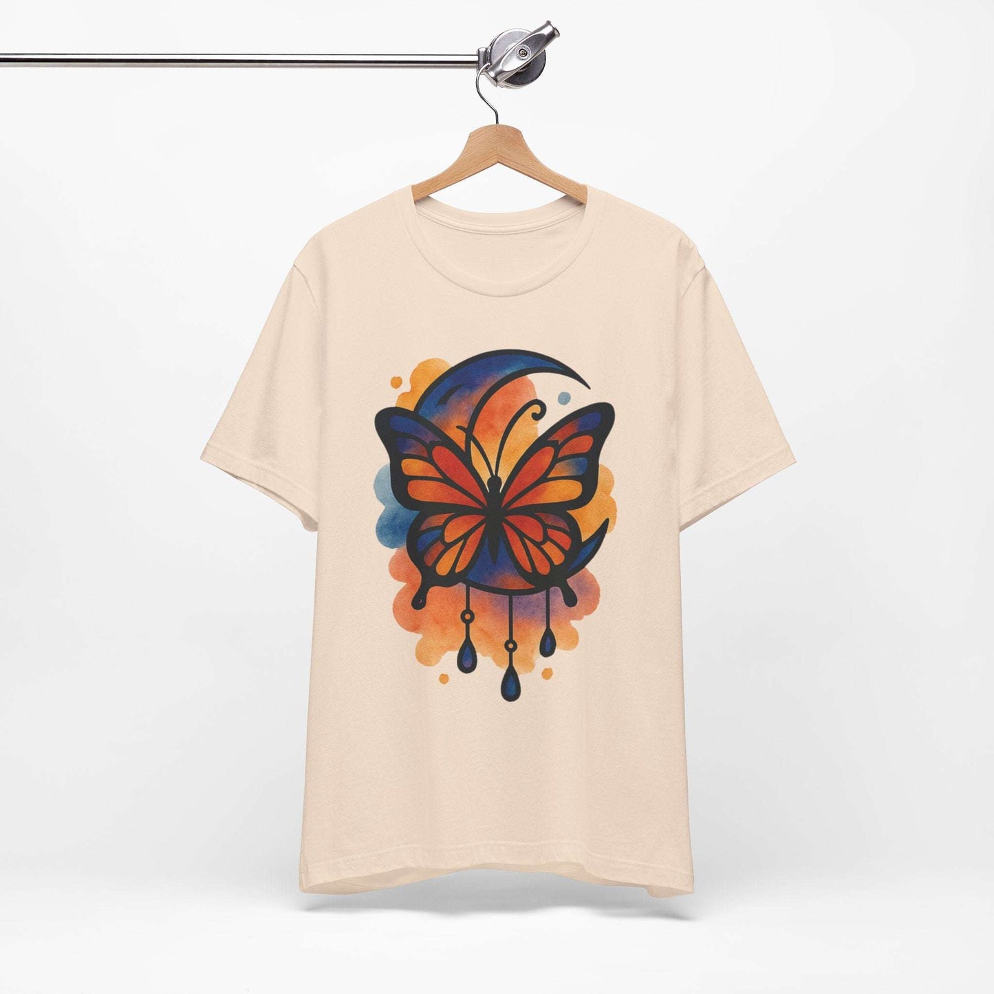 Beige t-shirt with a colorful butterfly design on a hanger against a white background