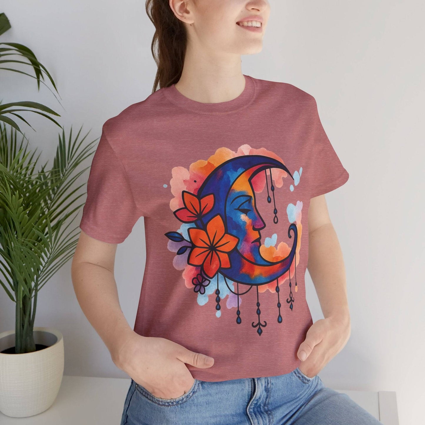 Heather mauve Colorful Boho Crescent Moon T-Shirt featuring a moon goddess face and floral watercolor art, ideal for spiritual apparel fans.