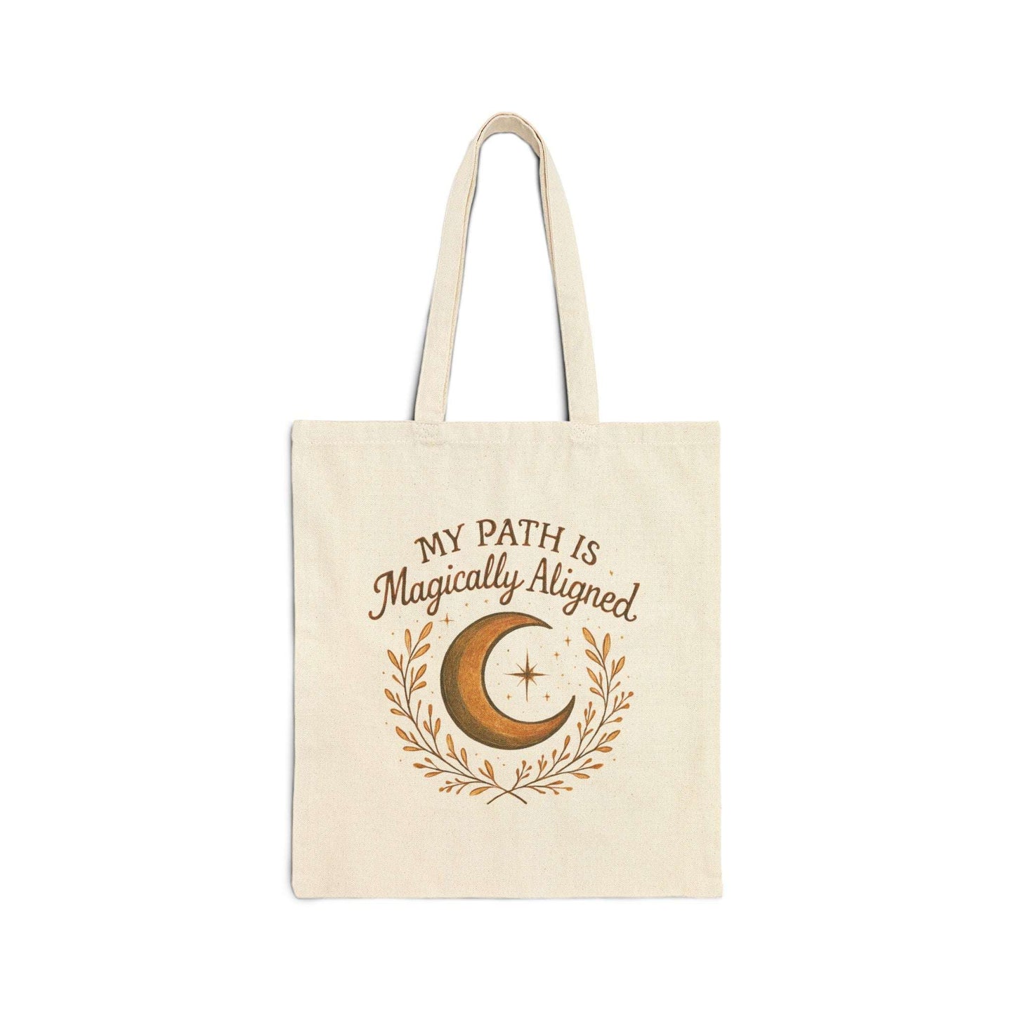 Flat-lay of Boho Moon Canvas Tote featuring crescent moon and stars design with 'My Path Is Magically Aligned' text. Eco-friendly and perfect for everyday use.