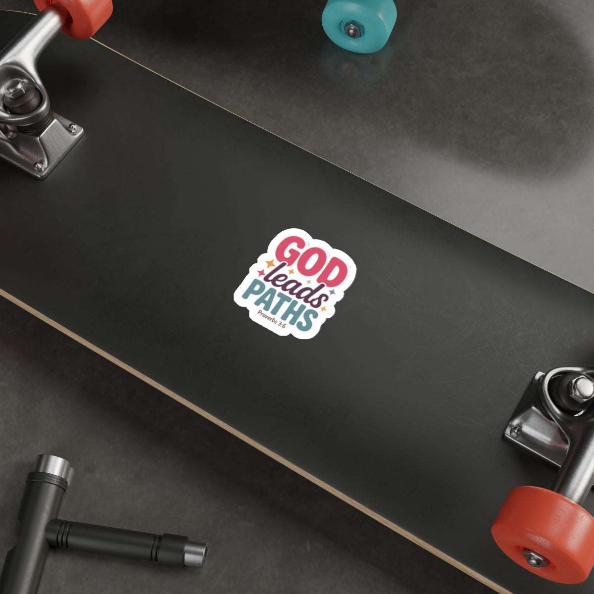 Faith-inspired God Leads Paths — Proverbs 3:6 Christian Die-Cut Sticker displayed on skateboard, durable for active lifestyle use.