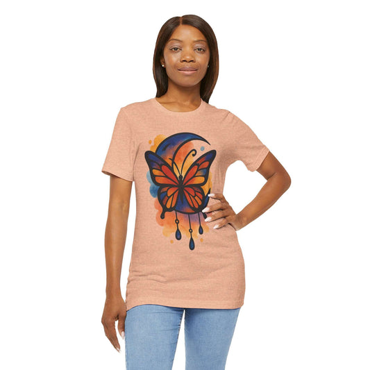 Woman wearing a peach t-shirt with a colorful butterfly design on a white background
