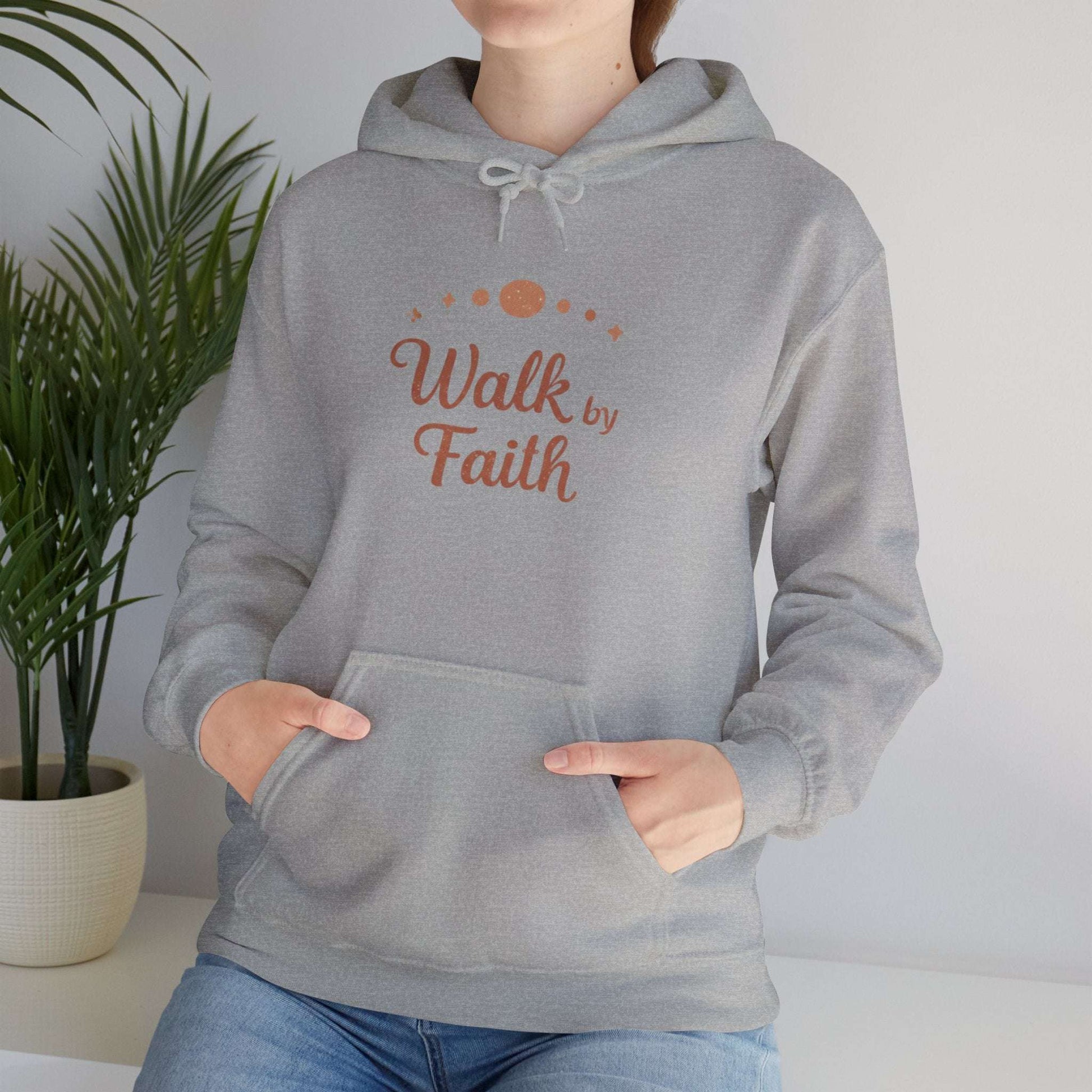 Faithful Walk Hoodie in heather gray with 'Walk by Faith' Christian design, worn by woman in casual indoor setting.