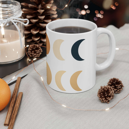Boho Moon Phase Mug – Neutral Earth Lunar Design Ceramic Cup with celestial crescent patterns, styled in cozy holiday setting with candle and pinecones.