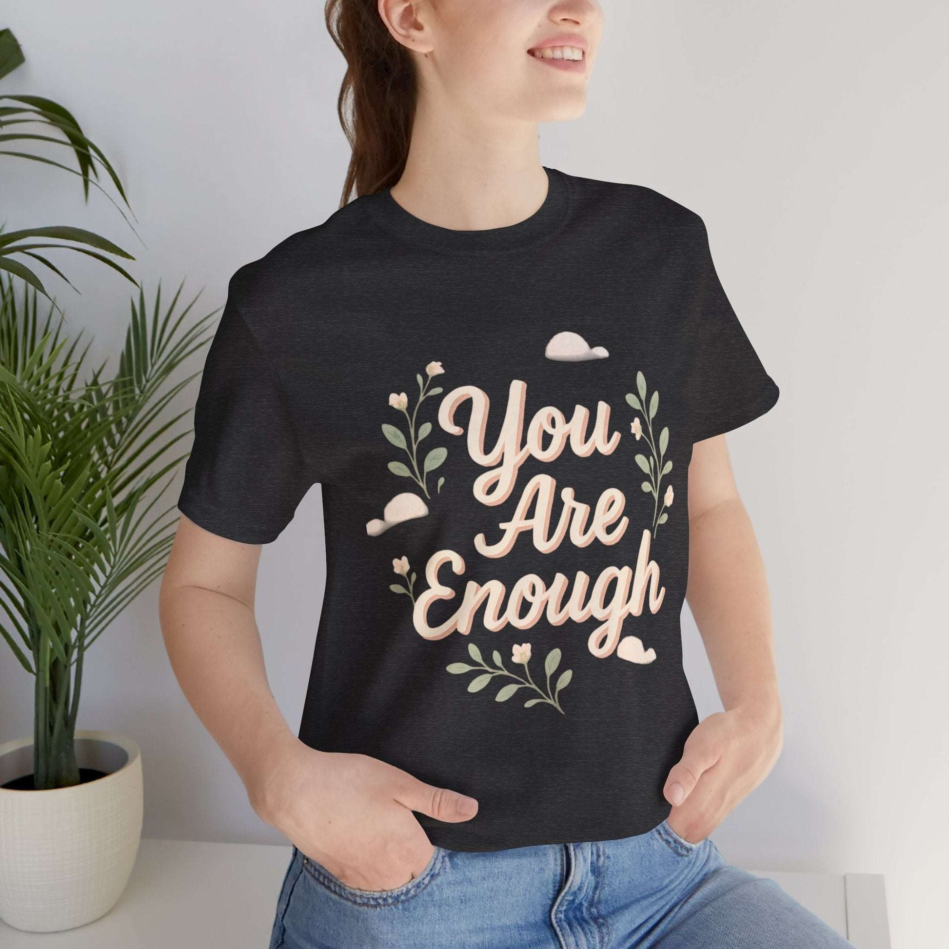 Floral Tee You Are Enough Unisex Jersey features pastel floral graphics and 'You Are Enough' text on a black short sleeve t-shirt. Ideal for casual wear with a message of self-love.