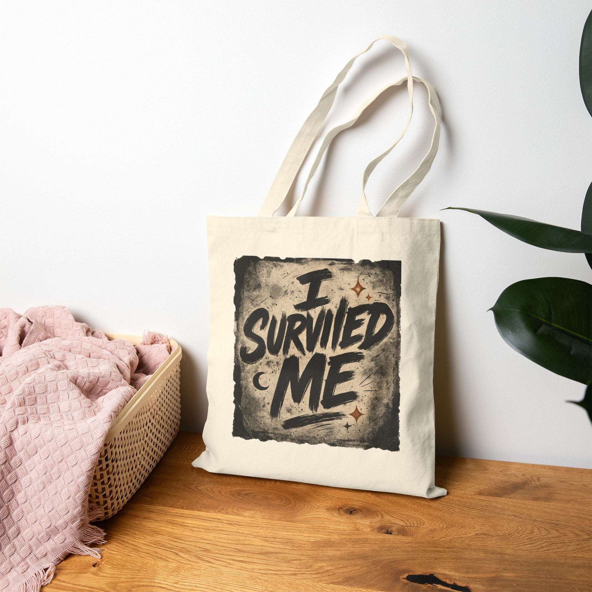 Inspirational beige tote bag with 'I Survived Me' print displayed on a wooden surface, perfect for self-love and resilience gifting.