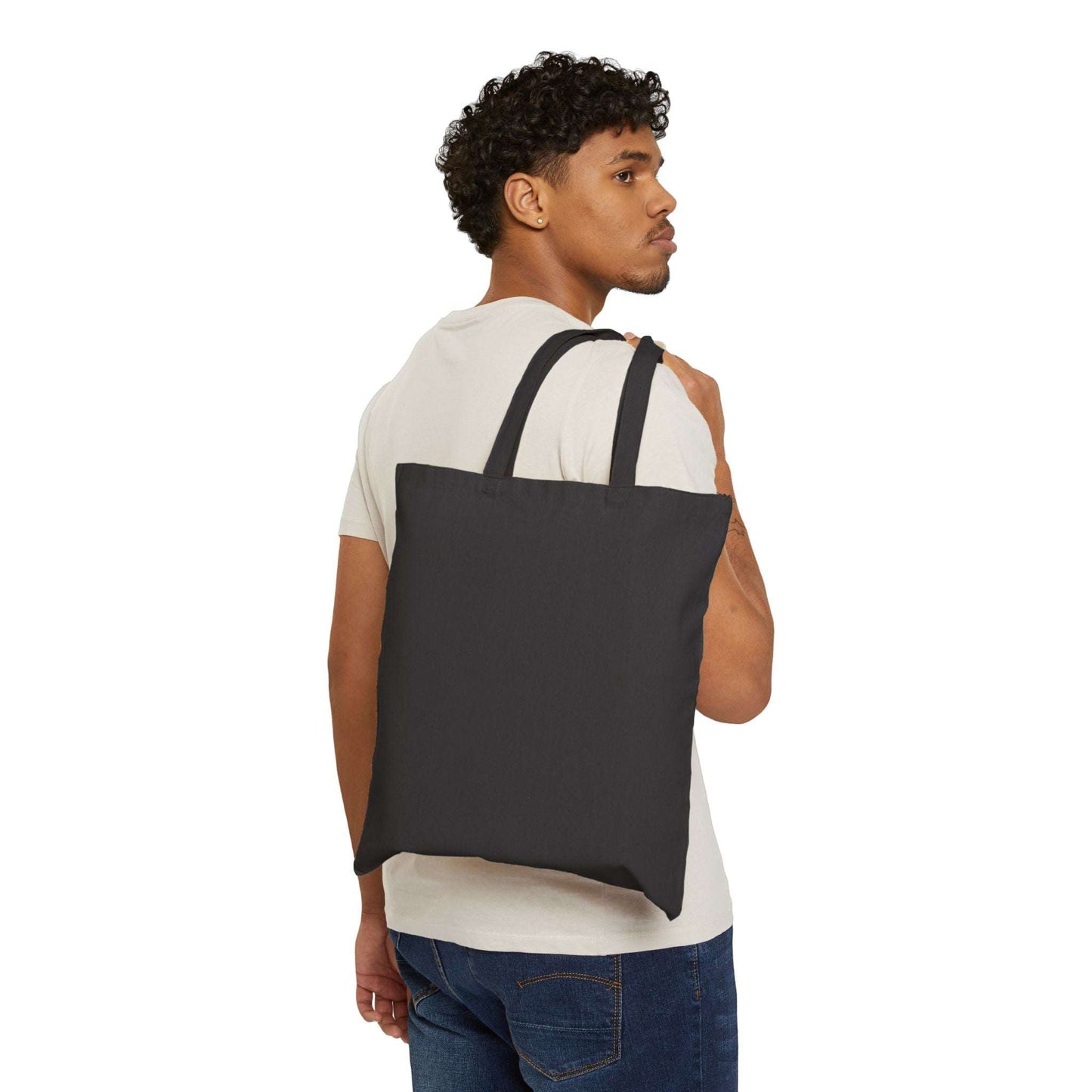 Man carrying a black tote bag on a white background and "balance" on bag
