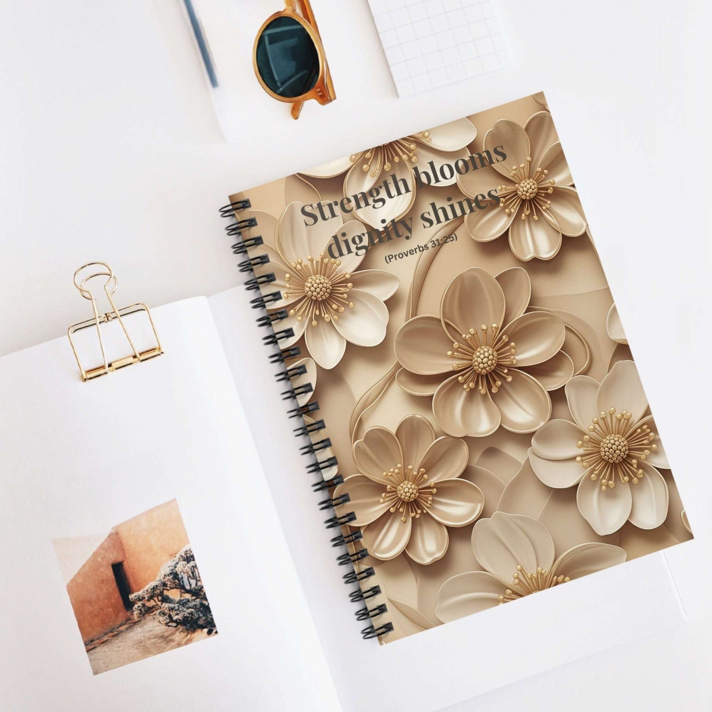 Inspirational Floral Spiral Notebook with beige 3D flower cover and Proverbs 31:25 verse, styled on a desk with office accessories.