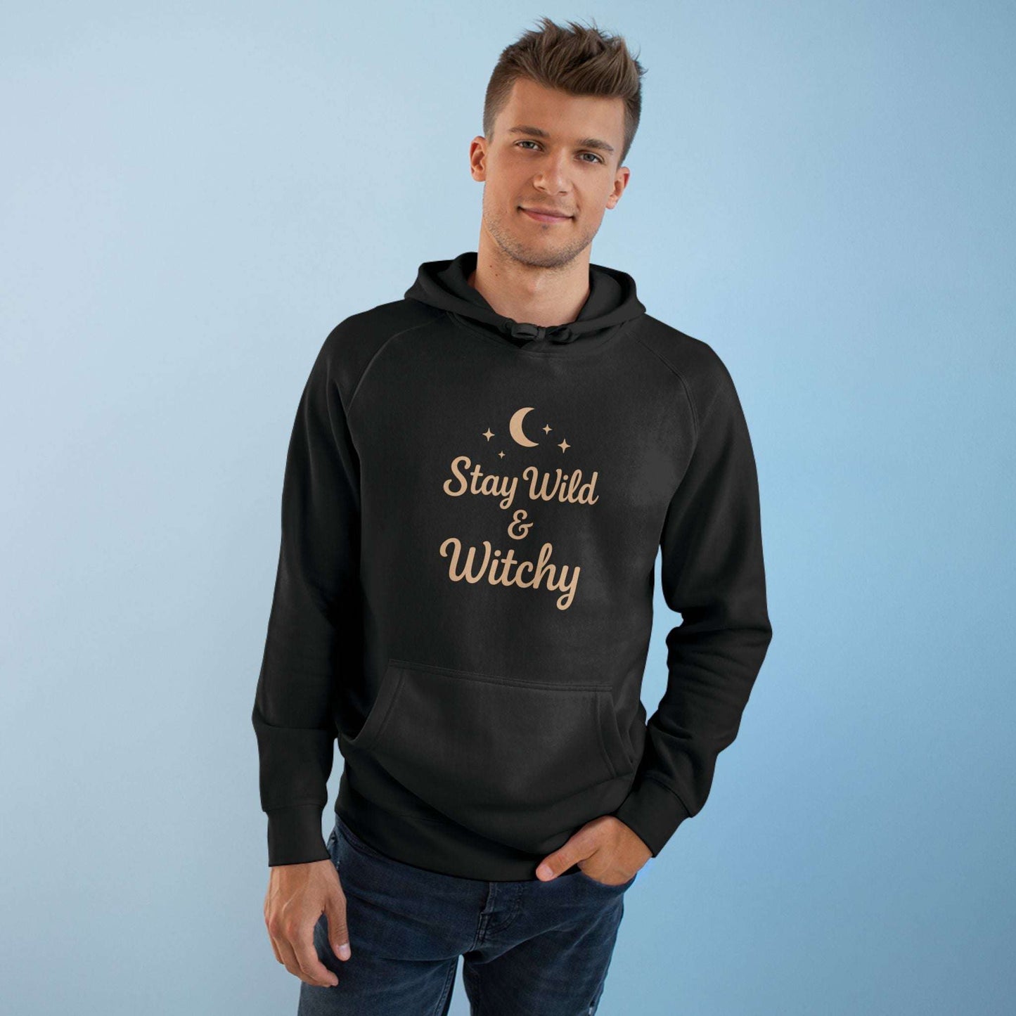 Man in black Witchy Supply Hoodie with 'Stay Wild & Witchy' text, combining comfort and hipster fashion for unisex wear.
