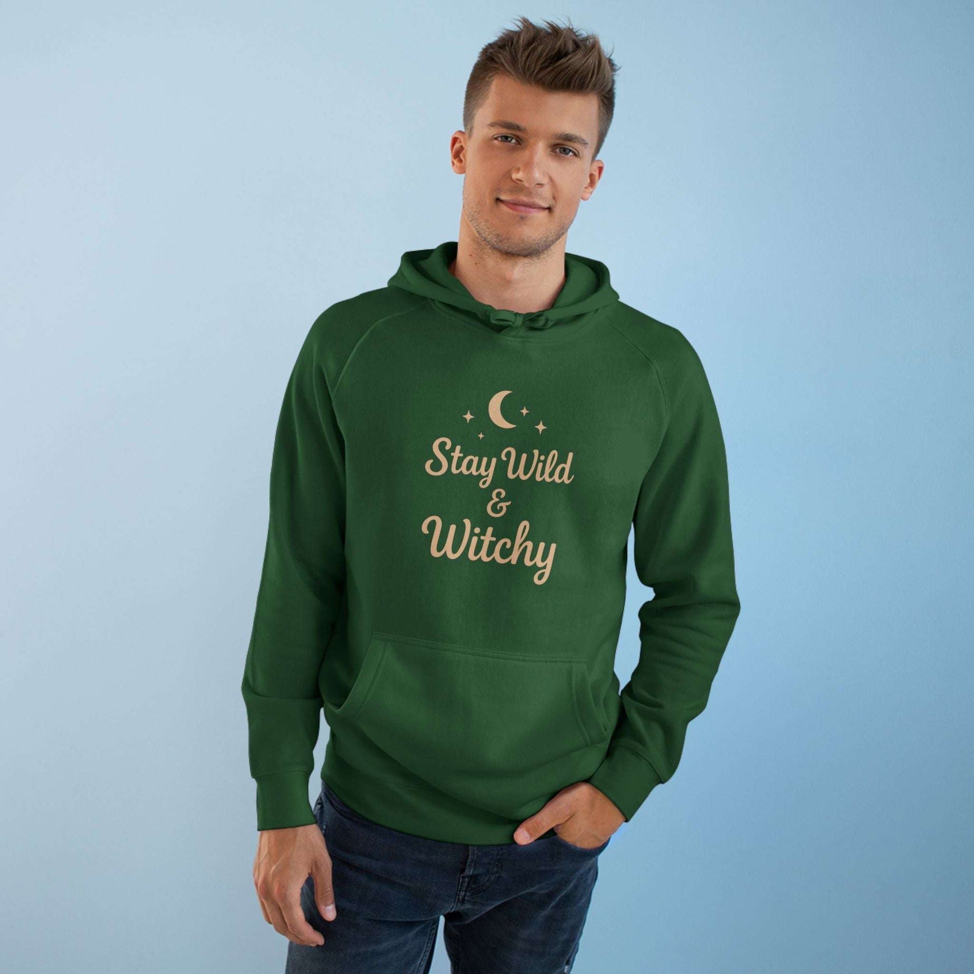 Man modeling green Witchy Supply Hoodie with 'Stay Wild & Witchy' text, perfect for gender-neutral mystical streetwear.