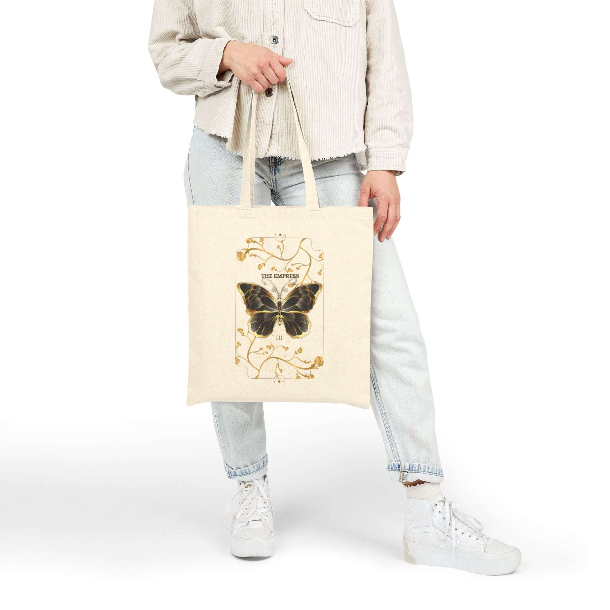 Model holding Butterfly Botanical Tote Bag with vintage butterfly tarot design, a stylish eco-friendly accessory for boho and nature-inspired outfits.
