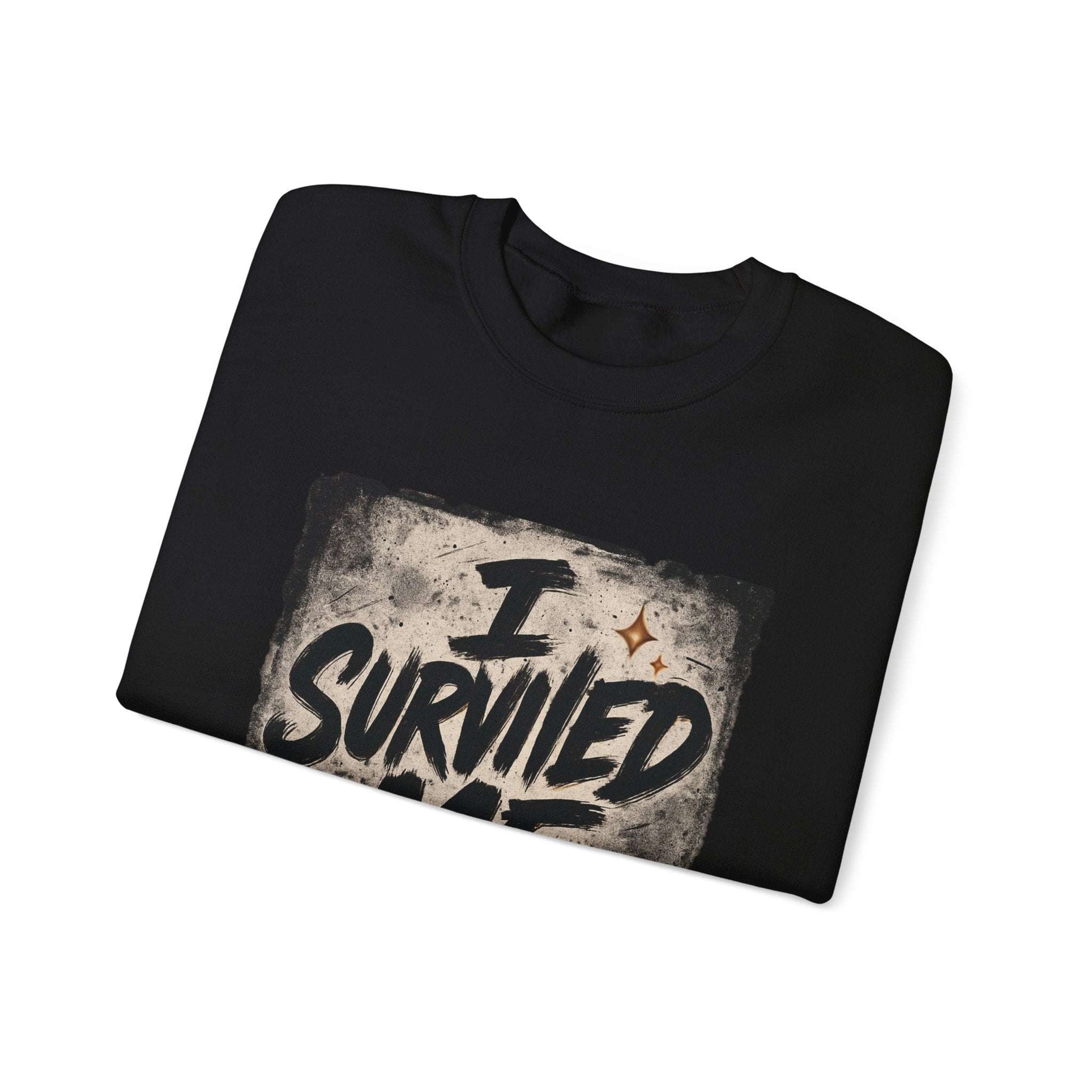 Folded black Survived Me Sweatshirt with bold grunge lettering, great for gifting supportive and motivational apparel.