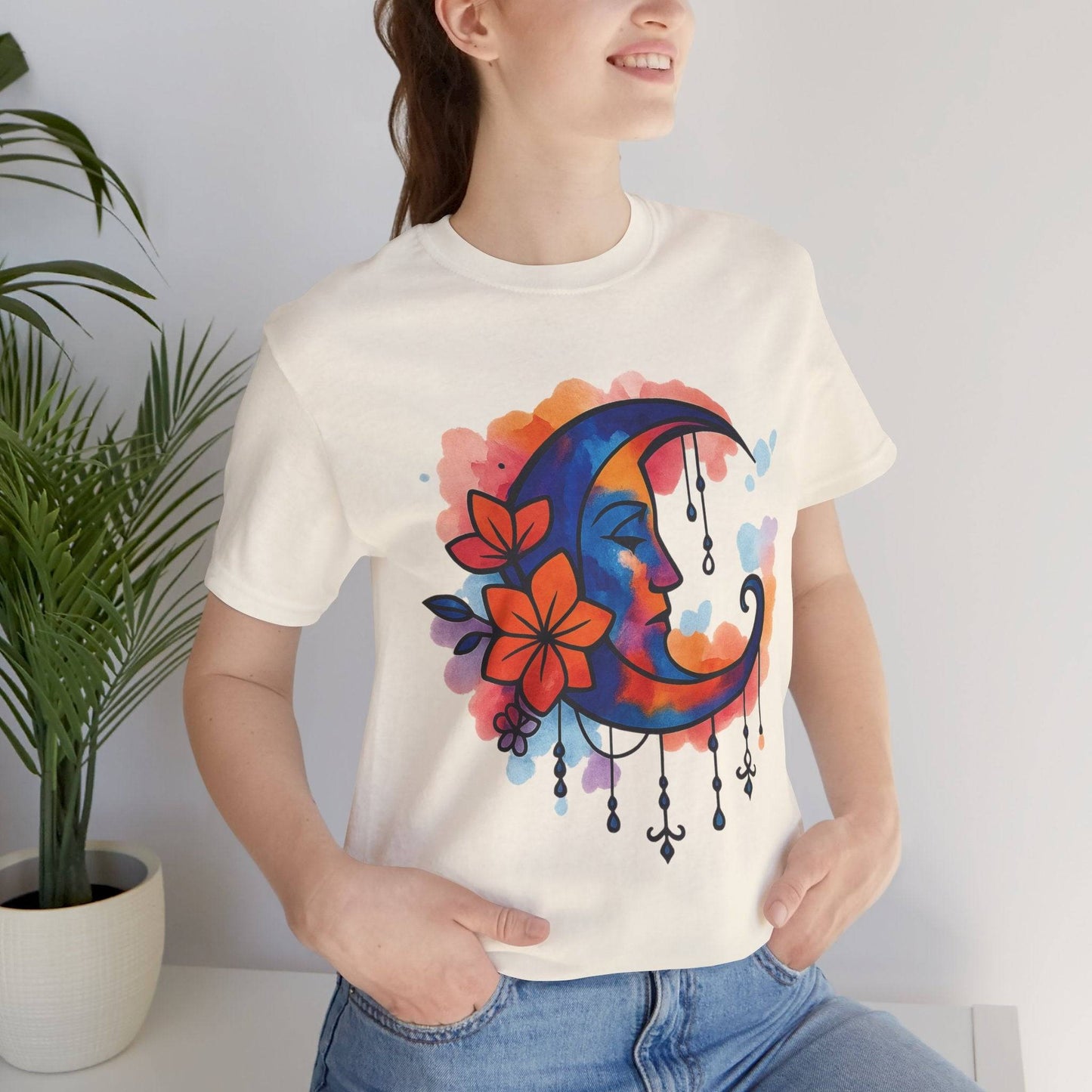 Cream Floral Moonface Goddess Tee with watercolor crescent moon and floral accents, a soft boho t-shirt for spiritual and artistic expression.