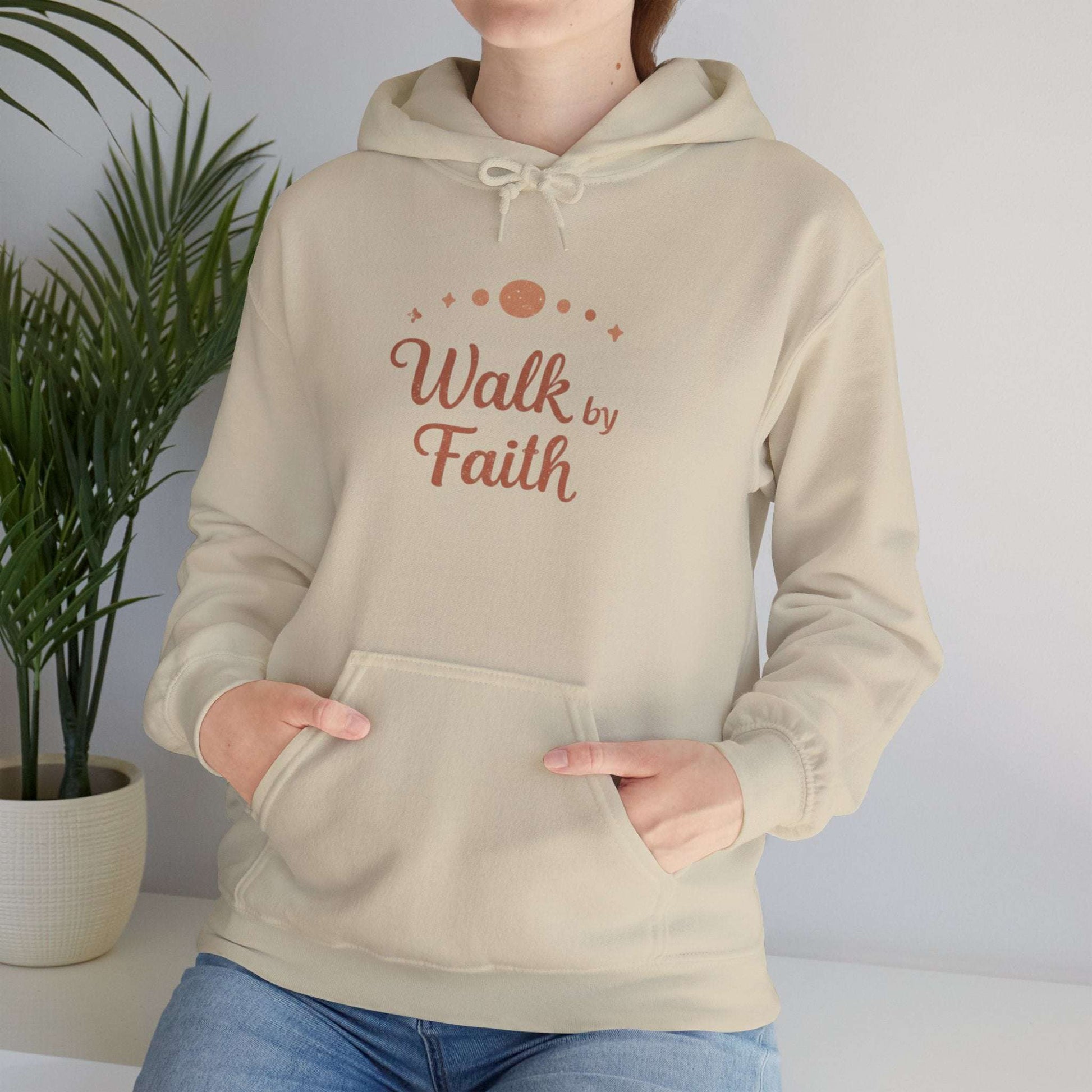 Beige Faithful Walk Hoodie worn by woman, displaying 'Walk by Faith' inspirational print for faith-based apparel lovers.