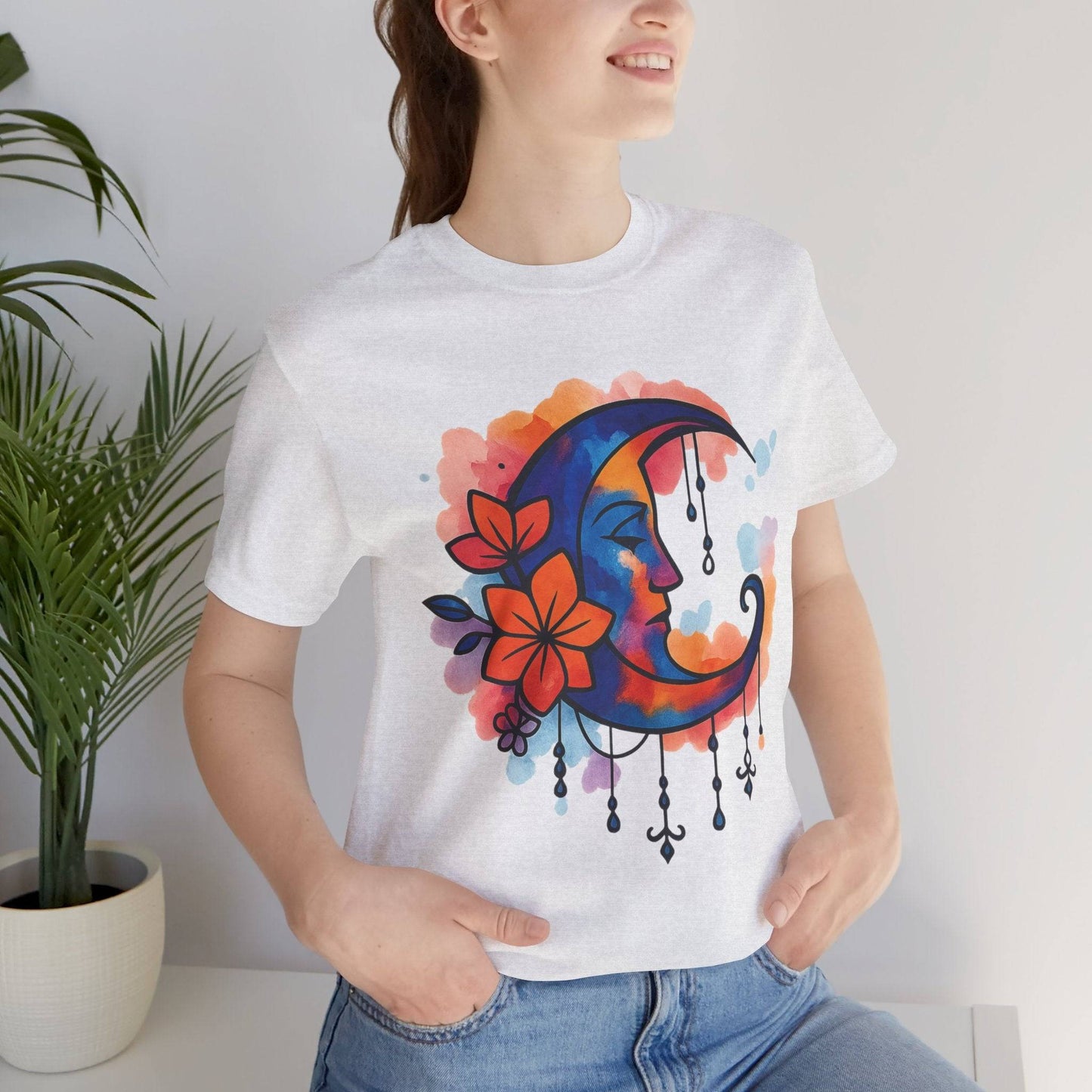 Heather white Colorful Boho Crescent Moon T-Shirt with watercolor moon goddess design and floral details, perfect for cozy, dreamy outfits.