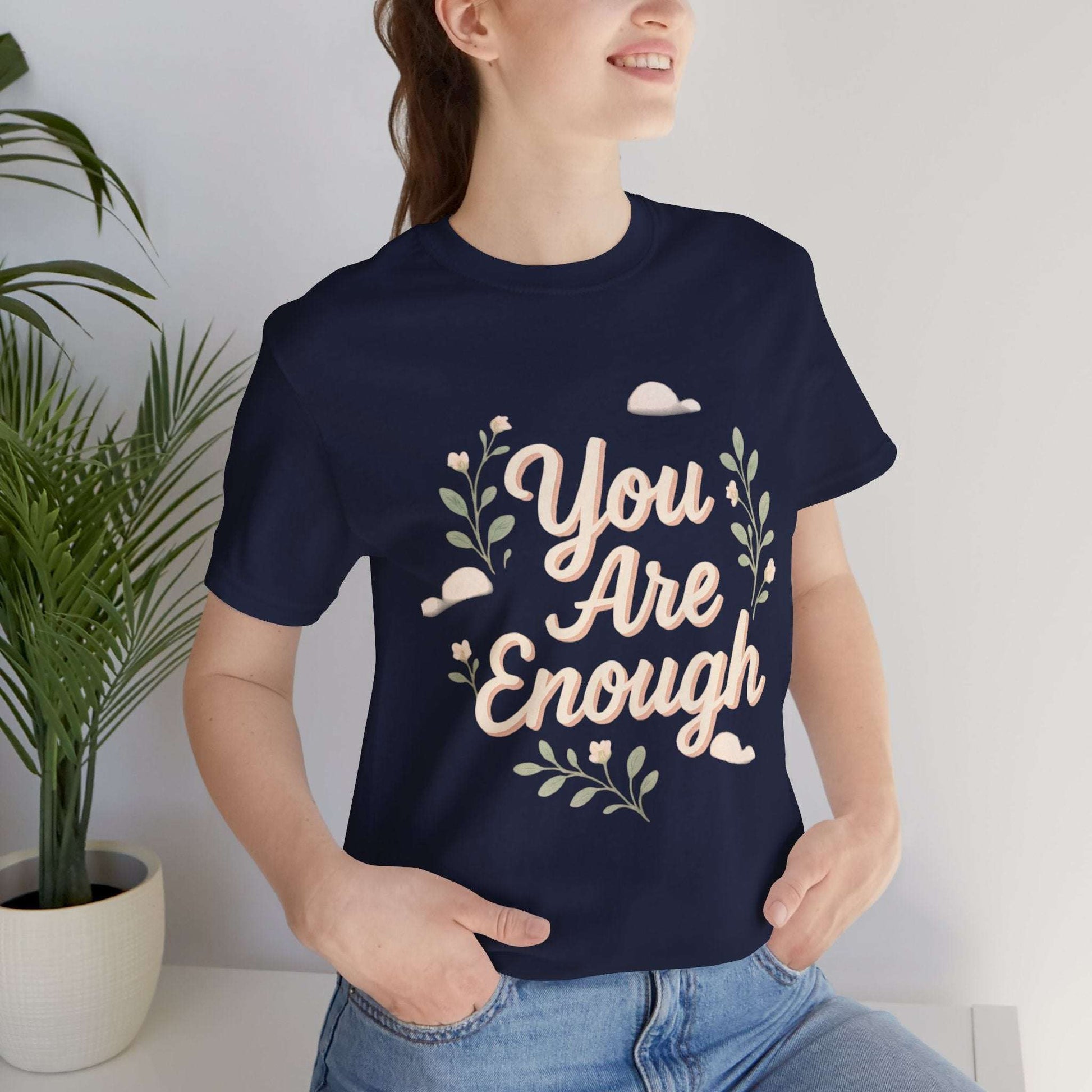 Navy Floral Tee You Are Enough Unisex Jersey on model, featuring pastel floral print and self-love message for daily wear.