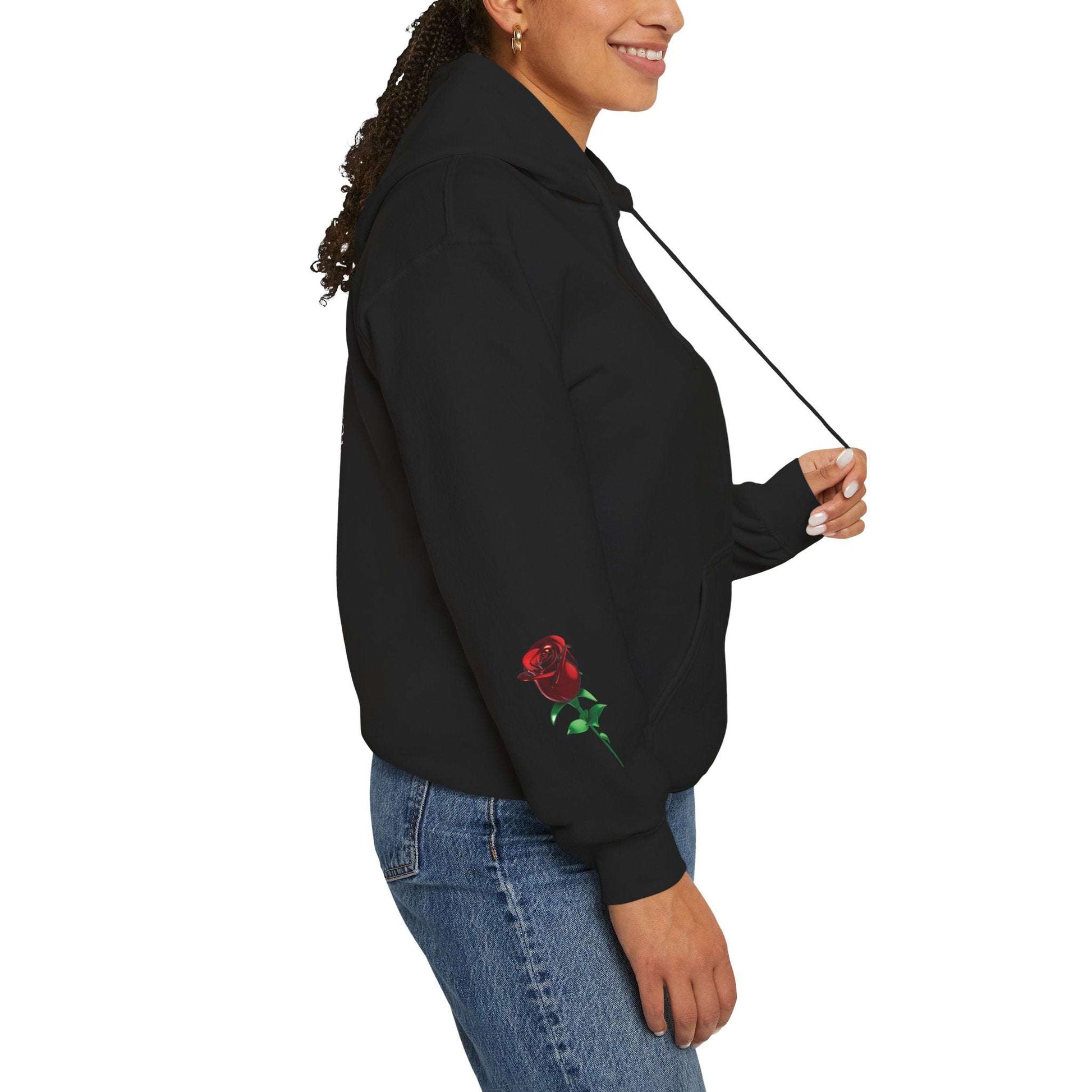 Person wearing a black hoodie with a red rose design on a white background